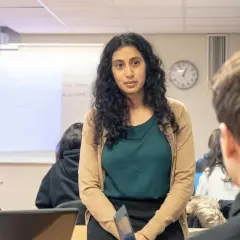 Lärare i en klassrumsmiljö på arena academy. Eleverna lyssnar uppmärksamt.