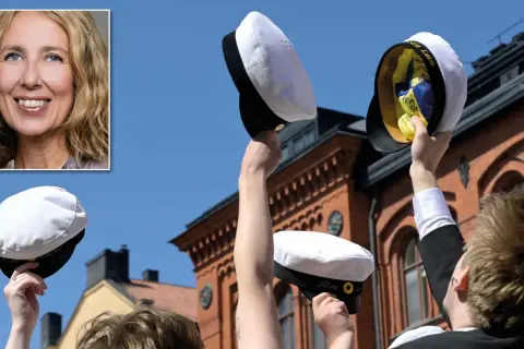 En kvinna ler, medan studenter firar med champagne och studentmössor. En milstolpe efter skolplikt gymnasiet.