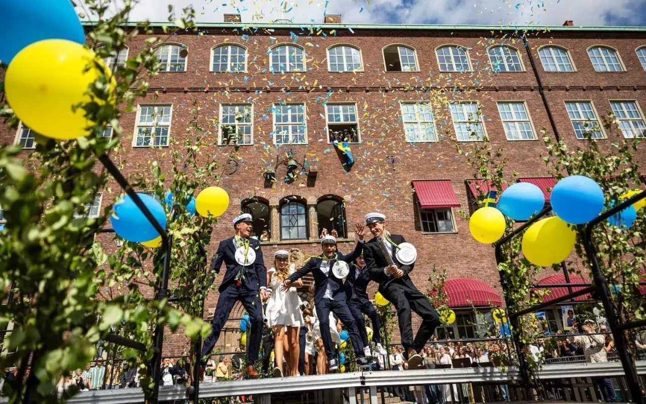 Studenter firar utspringet från Hvitfeldtska gymnasiet med konfetti och ballonger.